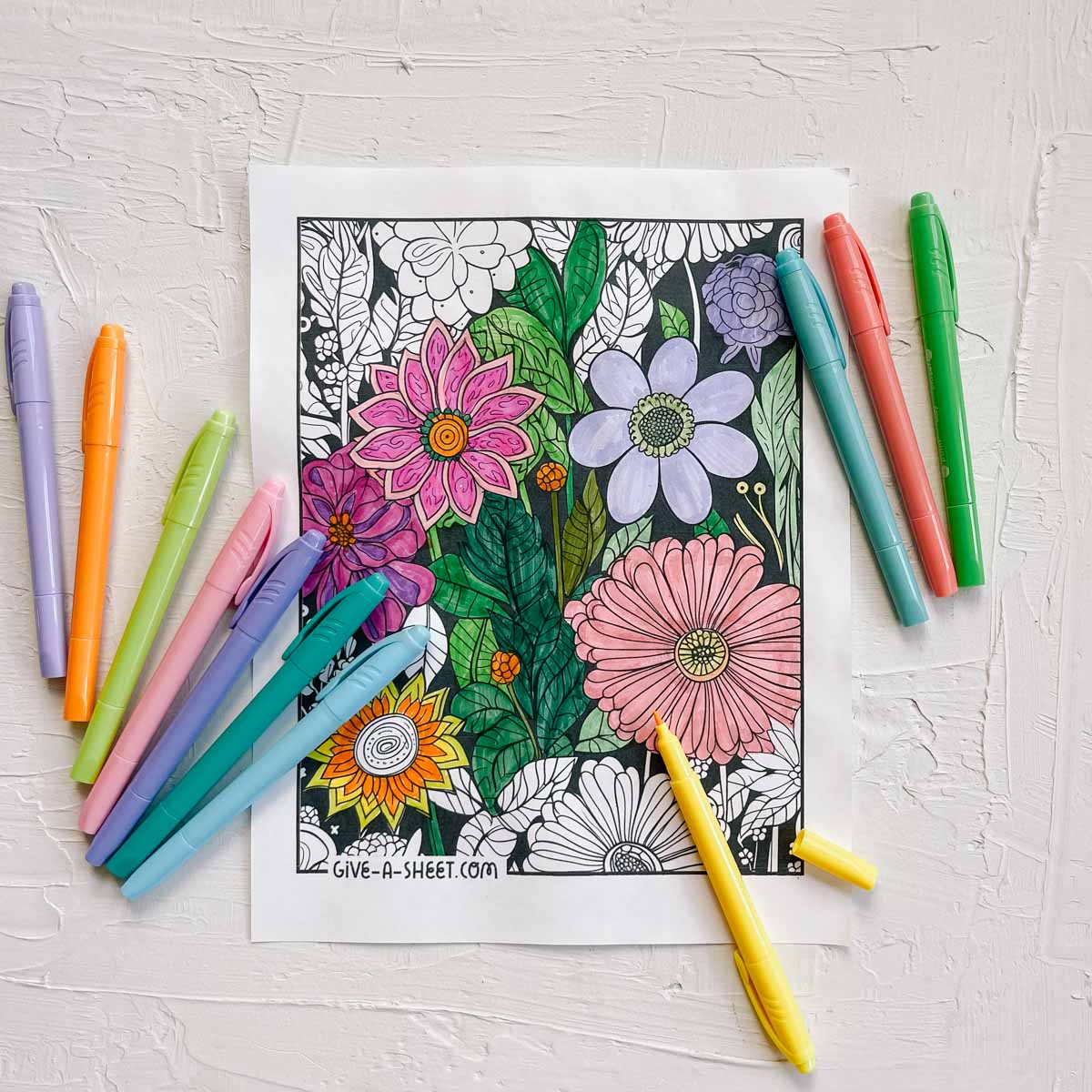 A detailed flower coloring sheet in progress of being colored.